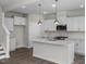 Bright kitchen featuring white cabinets, stainless steel appliances, and quartz countertops at 104 Fairwinds Dr, Lillington, NC 27546