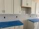 Close-up of kitchen cabinets and tile backsplash at 104 Fairwinds Dr, Lillington, NC 27546