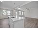 Open concept kitchen with island and stainless steel sink, adjacent to living area at 104 Fairwinds Dr, Lillington, NC 27546