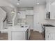 Stylish kitchen with island and stainless steel appliances, open to staircase at 104 Fairwinds Dr, Lillington, NC 27546