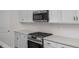 Stainless steel oven range and white patterned backsplash in a modern kitchen at 104 Fairwinds Dr, Lillington, NC 27546