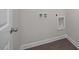 A convenient laundry room includes water hookups for easy appliance installation and wood look tile floors at 104 Fairwinds Dr, Lillington, NC 27546
