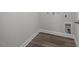 Laundry room features wood-look flooring and connections for washer and dryer at 104 Fairwinds Dr, Lillington, NC 27546
