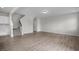 Spacious living area with hardwood floors, white walls, and a staircase at 104 Fairwinds Dr, Lillington, NC 27546