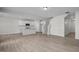 Open-concept living space with kitchen island, hardwood floors, and access to the staircase at 104 Fairwinds Dr, Lillington, NC 27546