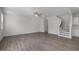 Bright and airy living room featuring hardwood floors and staircase with access to kitchen at 104 Fairwinds Dr, Lillington, NC 27546