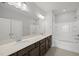 Bright bathroom featuring double vanity, large mirror, and a shower-tub combination with white subway tile at 104 Ripple Way # 318, Clayton, NC 27520