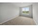 Carpeted bedroom with a large window, and natural light at 104 Ripple Way # 318, Clayton, NC 27520