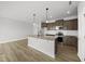 Well-lit kitchen with a granite island, stainless steel appliances, and dark wood cabinetry at 104 Ripple Way # 318, Clayton, NC 27520