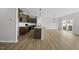 Spacious kitchen featuring an island, stainless steel appliances, and wood-look flooring throughout the main level at 104 Ripple Way # 318, Clayton, NC 27520
