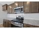Close-up of a kitchen featuring stainless steel appliances, white subway tile backsplash, and granite countertops at 104 Ripple Way # 318, Clayton, NC 27520