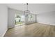 Bright living room showcasing natural light, sliding glass doors, and wood-look flooring at 104 Ripple Way # 318, Clayton, NC 27520