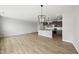 Open concept living area that flows into kitchen, wood-look flooring, and modern lighting at 104 Ripple Way # 318, Clayton, NC 27520