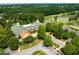 Aerial view showcasing clubhouse architecture, green landscape, and parking areas, enhancing community appeal at 10400 Rosegate Ct # 3, Raleigh, NC 27617