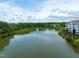 Breathtaking aerial view of a pond with a fountain, surrounded by trees and residential buildings, offering a peaceful setting at 10400 Rosegate Ct # 3, Raleigh, NC 27617