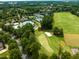 Aerial view of a golf course with a sand trap and a pool and tennis courts area, creating a luxury recreational setting at 10400 Rosegate Ct # 3, Raleigh, NC 27617