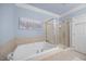 Bright bathroom with a soaking tub and a glass-enclosed shower at 10400 Rosegate Ct # 3, Raleigh, NC 27617