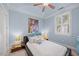 Bedroom with unique decor featuring blue walls, a ceiling fan, and modern furniture at 10400 Rosegate Ct # 3, Raleigh, NC 27617