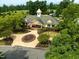 Welcoming clubhouse with peaked roof, flag pole and beautiful landscaping in a lovely community at 10400 Rosegate Ct # 3, Raleigh, NC 27617