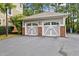 Detached two-car garage with brick accents and a paved driveway, offering ample parking space at 10400 Rosegate Ct # 3, Raleigh, NC 27617