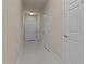 Clean hallway with multiple doors, neutral colors, and bright overhead lighting at 10400 Rosegate Ct # 3, Raleigh, NC 27617