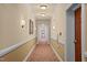 Long hallway with neutral walls, decorative sconces, and patterned carpeting leading to residential units at 10400 Rosegate Ct # 3, Raleigh, NC 27617