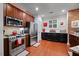 Well-equipped kitchen with stainless steel appliances, granite counters, and dark wood cabinets at 10400 Rosegate Ct # 3, Raleigh, NC 27617