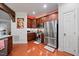 Modern kitchen featuring stainless steel appliances and cherry wood cabinets at 10400 Rosegate Ct # 3, Raleigh, NC 27617