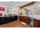 Well-appointed kitchen featuring modern appliances, granite countertops, and mixed wood tone cabinetry at 10400 Rosegate Ct # 3, Raleigh, NC 27617