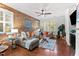 Cozy living room featuring exposed brick wall, hardwood floors, and stylish decor at 10400 Rosegate Ct # 3, Raleigh, NC 27617