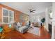 Inviting living room featuring a brick accent wall and plush grey sectional at 10400 Rosegate Ct # 3, Raleigh, NC 27617