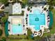Aerial view of a resort-style pool area with multiple pools, lounge chairs, and recreational amenities at 10400 Rosegate Ct # 3, Raleigh, NC 27617
