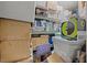 A cluttered storage area featuring shelving with boxes and miscellaneous household items at 10400 Rosegate Ct # 3, Raleigh, NC 27617