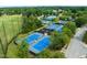 Aerial view of community tennis courts and wooded area, with multiple courts at 10400 Rosegate Ct # 3, Raleigh, NC 27617