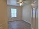 Bright bedroom with a ceiling fan, a window for natural light and durable flooring at 11711 Mezzanine Dr # 109, Raleigh, NC 27614