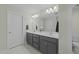 Bathroom featuring double sinks with gray cabinets, white countertop and tile flooring at 118 Lockhaven Dr, Garner, NC 27529