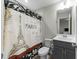 Neutral bathroom featuring a Paris-themed shower curtain, a white toilet, and a vanity with a sink at 118 Lockhaven Dr, Garner, NC 27529