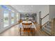 Open concept dining room featuring natural light, hardwood floors, and gray walls at 118 Lockhaven Dr, Garner, NC 27529