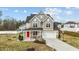 Beautiful two-story home featuring gray and tan siding, covered front porch and well-manicured landscaping at 118 Lockhaven Dr, Garner, NC 27529