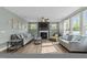 Spacious living room featuring a decorative fireplace, a ceiling fan, and ample natural light at 118 Lockhaven Dr, Garner, NC 27529