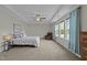 Spacious main bedroom featuring a tray ceiling, ceiling fan and windows with a sitting area at 118 Lockhaven Dr, Garner, NC 27529