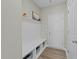 Functional mudroom with a built-in bench, storage shelves, hooks and access to the garage at 118 Lockhaven Dr, Garner, NC 27529