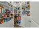 A walk-in pantry featuring white shelving, and organized storage for food and supplies at 118 Lockhaven Dr, Garner, NC 27529
