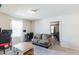 Carpeted bedroom featuring a cozy couch, a desk for studying, and an open doorway at 1253 Manor Dr, Rocky Mount, NC 27804