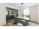 Bright dining room with a long table and a gray bench beneath a modern chandelier at 1253 Manor Dr, Rocky Mount, NC 27804