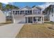 Charming two-story home with gray brick facade, a well-manicured lawn, and attached two-car garage at 1253 Manor Dr, Rocky Mount, NC 27804