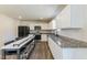 Modern kitchen with white cabinets, stainless steel appliances, and a bar with seating at 1253 Manor Dr, Rocky Mount, NC 27804