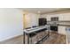 Bright kitchen with white cabinets, black refrigerator, and a bar with seating for four at 1253 Manor Dr, Rocky Mount, NC 27804