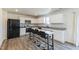 Modern kitchen featuring white cabinets, granite countertops, and a black refrigerator and appliances at 1253 Manor Dr, Rocky Mount, NC 27804