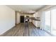 Bright eat-in kitchen with wood floors, black appliances, and sliding glass doors to the backyard at 1253 Manor Dr, Rocky Mount, NC 27804